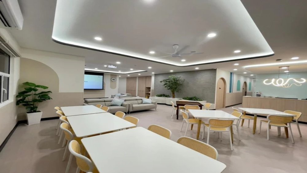 A modern premium nursing centre — bright, spacious communal lounge and dining area
